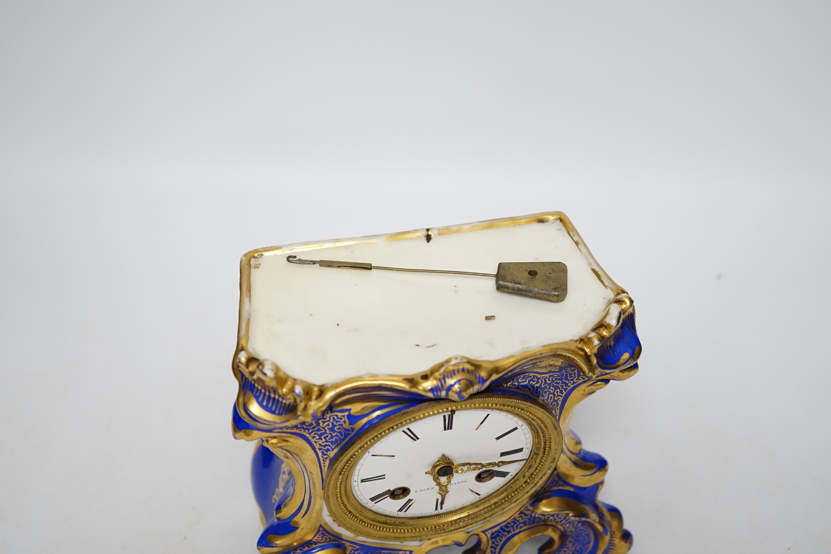 An early 20th century French porcelain mantel clock, missing top section, 19cm